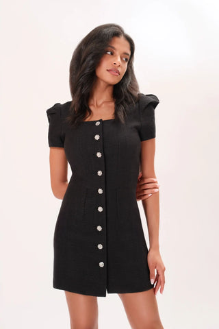 Close up of model wearing a black Amelie Tweed Dress by Chloe Colette.