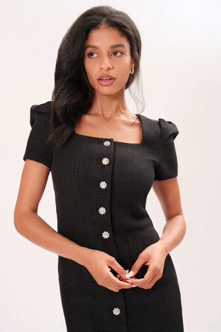 Close up of model wearing a black Amelie Tweed Dress by Chloe Colette.