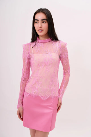 The model is wearing a pink rose Madonna lace Top and Jenny Mini Skirt by Chloe Colette.