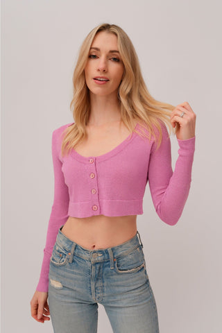 The model is wearing a rose quartz Glitz Cardi top by Chloe Colette showing the front side.