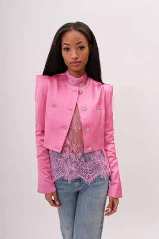 The model is wearing a juliette satin jacket in pink pearl and Jenny Mini Skirt by Chloe Colette