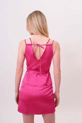 The model is wearing a rosolite Mykonos Satin Top and Jenny Mini Skirt by Chloe Colette.