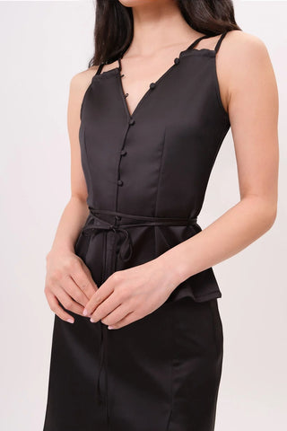 The model is wearing a tourmaline Mykonos Satin Top and Jenny Mini Skirt by Chloe Colette.