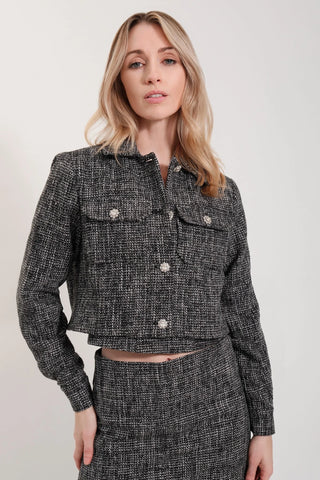 The model is wearing a black opal Vivienne Tweed Jacket by Chloe Colette.