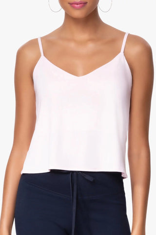 Model is wearing a pink Cassi v neck cami by Chloe Colette.