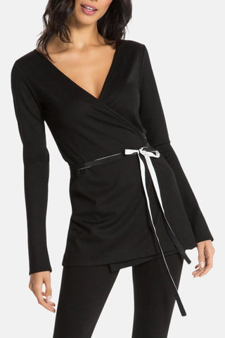 Model is wearing a black Clair Wrap Tunic by Chloe Colette.