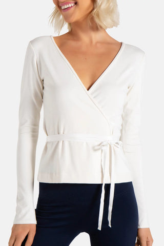 Model is wearing a ivory Clair Wrap Tunic by Chloe Colette.