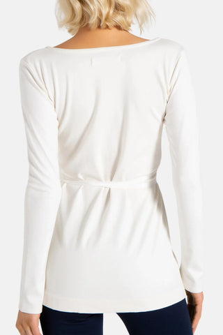 Model is wearing a ivory Clair Wrap Tunic by Chloe Colette.