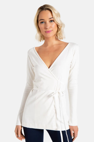 Model is wearing a ivory Clair Wrap Tunic by Chloe Colette.