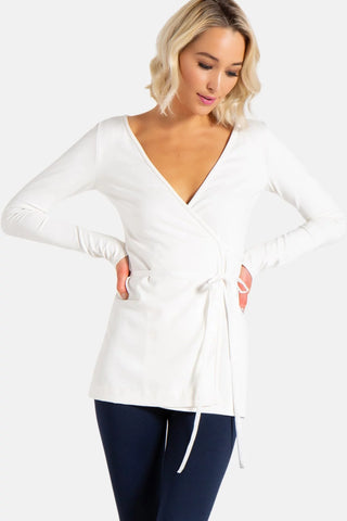 Model is wearing a ivory Clair Wrap Tunic by Chloe Colette.