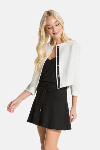 Model is wearing a ivory coco classic women's jacket by Chloe Colette.