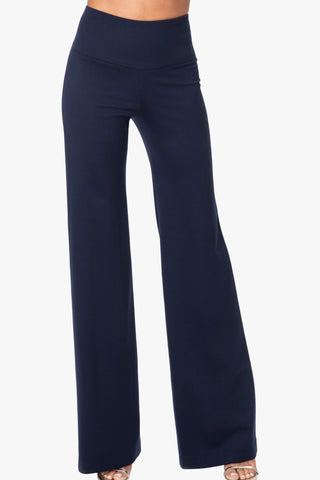 Model wearing a pair of navy Francesca wide leg pants by Chloe Colette.