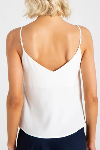 Model wearing a white silk strappy cami v-neck Jennifer by Chloe Colette.