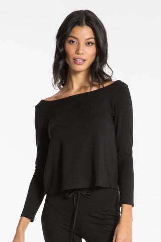 Model is wearing a black Lexi boat neck tee by Chloe Colette.