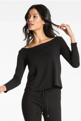 Model is wearing a black Lexi boat neck tee by Chloe Colette.