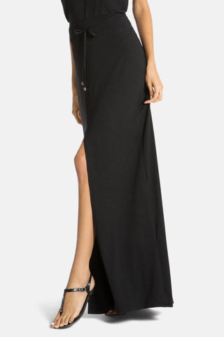 Model is wearing a black Miami maxi skirt by Chloe Colette.