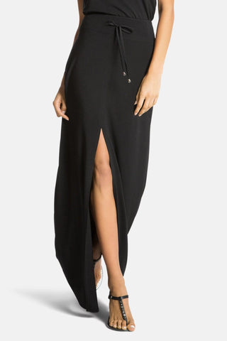 Model is wearing a black Miami maxi skirt by Chloe Colette.