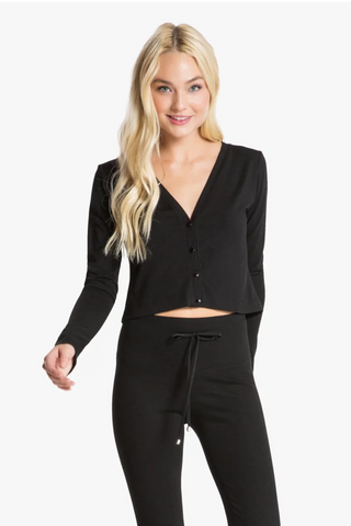 Model is wearing a black Natasha cardigan by Chloe Colette.