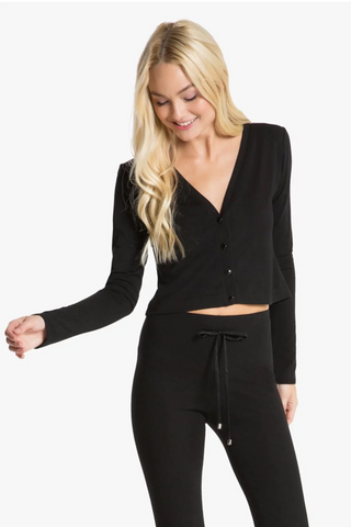 Model is wearing a black Natasha cardigan by Chloe Colette.