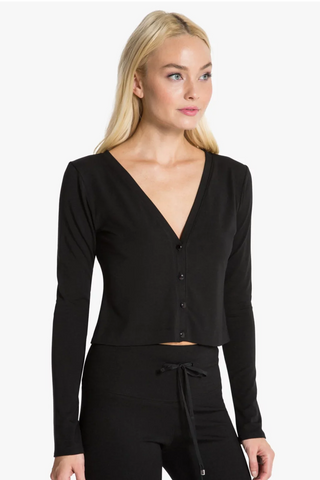 Model is wearing a black Natasha cardigan by Chloe Colette.