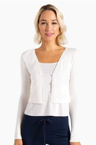 Model is wearing a white Natasha cardigan by Chloe Colette.