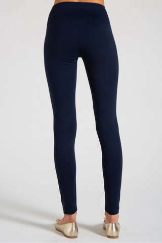 Model is wearing a navy New York long legging by Chloe Colette.