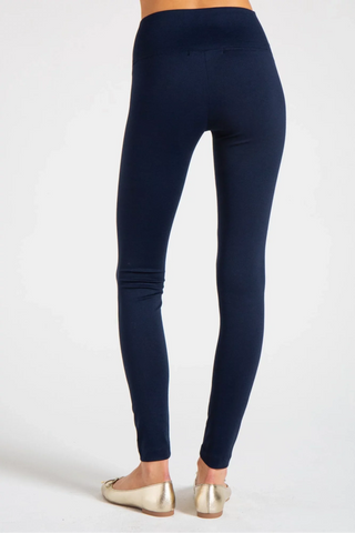 Model is wearing a navy New York long legging by Chloe Colette.