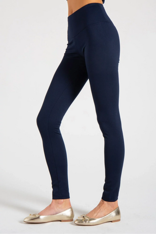 Model is wearing a navy New York long legging by Chloe Colette.