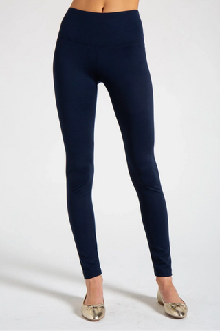 Model is wearing a navy New York long legging by Chloe Colette.
