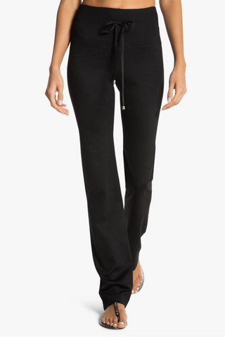 Model is wearing a black Ricky straight leg pant by Chloe Colette.