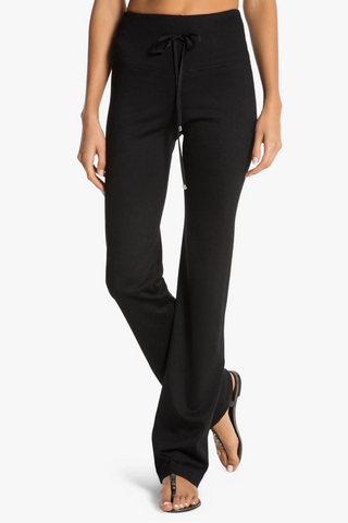 Model is wearing a black Ricky straight leg pant by Chloe Colette.