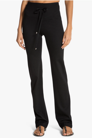 Model is wearing a black Ricky straight leg pant by Chloe Colette.