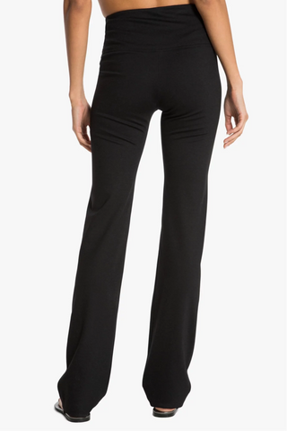 Model is wearing a black Ricky straight leg pant by Chloe Colette.
