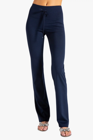 Model is wearing a navy Ricky straight leg pant by Chloe Colette.
