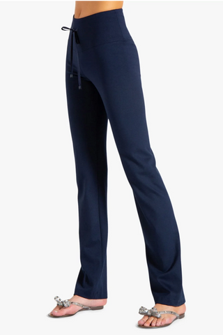 Model is wearing a navy Ricky straight leg pant by Chloe Colette.