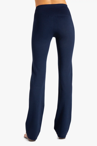 Model is wearing a navy Ricky straight leg pant by Chloe Colette.