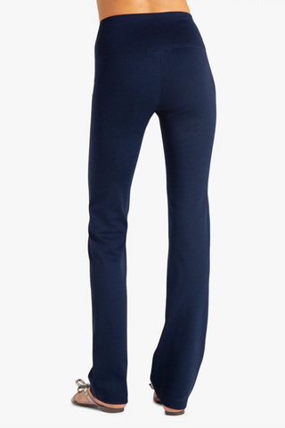 Model is wearing a navy Ricky straight leg pant by Chloe Colette.