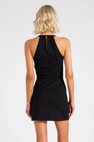 Model is wearing a pindot Odessa fitted mini dress by Chloe Colette.