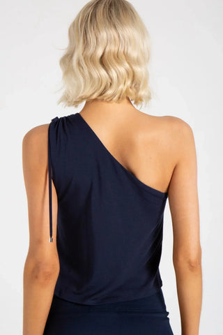 Model is wearing a blue Julie on shoulder top by Chloe Colette.