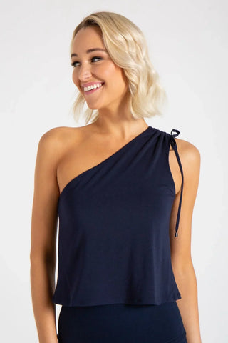 Model is wearing a blue Julie on shoulder top by Chloe Colette.
