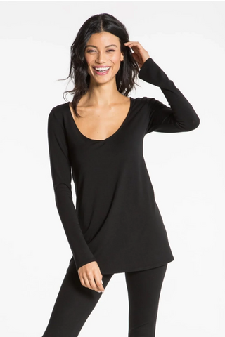 Model is wearing a black Sonja long sleeve tunic tee by Chloe Colette.