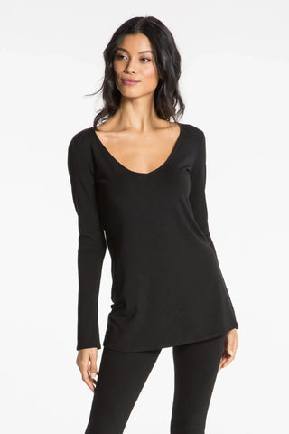 Model is wearing a black Sonja long sleeve tunic tee by Chloe Colette.