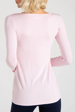 Model is wearing a black Sonja long sleeve tunic tee by Chloe Colette.