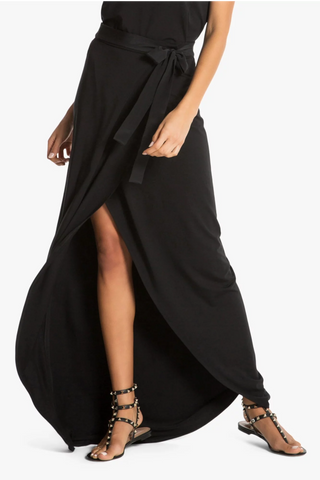 Model wearing a black maxi skirt St Tropez by Chloe Colette