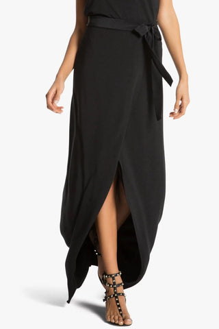 Model wearing a black maxi skirt St Tropez by Chloe Colette