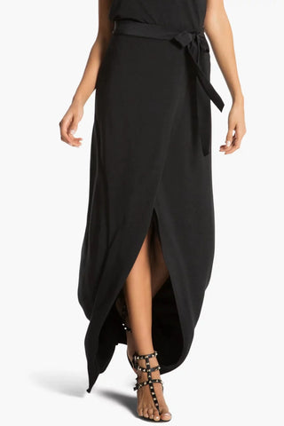 Model is wearing a black St Tropez maxi skirt by Chloe Colette.