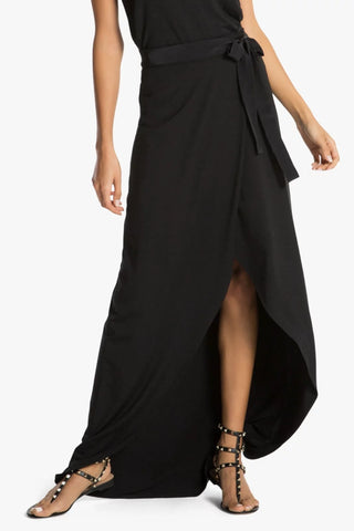 Model wearing a black maxi skirt St Tropez by Chloe Colette