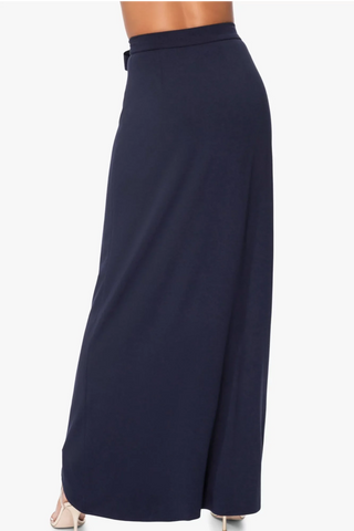 Model is wearing a navy St Tropez maxi skirt by Chloe Colette.