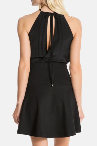 Model is wearing a black Stephanie mini dress by Chloe Colette.