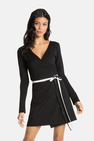 Model is wearing a black mini dress  Edith by Chloe Colette.